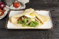 ÃÂ¡repe with salad and egg. Hot main course for breakfast or lunch of pancakes with fried egg, Royalty Free Stock Photo